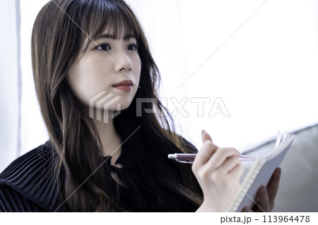 メモをとる若い女性 113964478