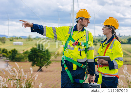 Engineer team working group survey at wind turbine clean power generator service maintenance wind mill outdoor. 113967046
