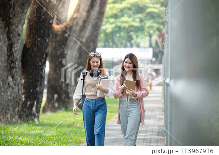 University student girl friends with learning book college while walking in campus 113967916