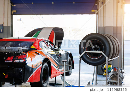 Back view Nascar Whelen euro series racing sportscar vehicle    Motorsport Arena garage box race track pit paddock hanged on hydraulic  jack lift with open hood. European motor auto sport competition 113968526