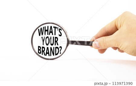 Branding what is your brand symbol. Concept words What is your brand in beautiful magnifying glass. Beautiful white background. Businessman hand. Business branding what your brand concept. Copy space. 113971390