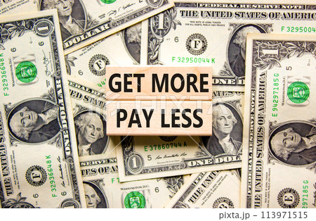 Get more pay less symbol. Concept words Get more pay less on wooden blocks on a beautiful background from dollar bills. Business Get more pay less concept. Copy space. Get more pay less symbol. Concept words Get more pay less on wooden blocks on a beautiful background from dollar bills. Business Get more pay less concept. Copy space. 113971515