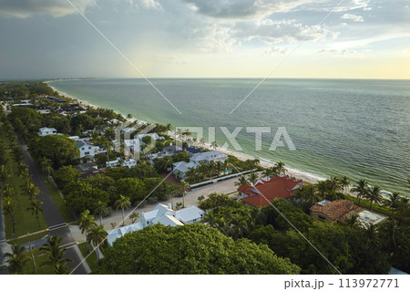 View from above of large residential houses in island small town Boca Grande on Gasparilla Island in southwest Florida. American dream homes as example of real estate development in US suburbs View from above of large residential houses in island small town Boca Grande on Gasparilla Island in southwest Florida. American dream homes as example of real estate development in US suburbs 113972771