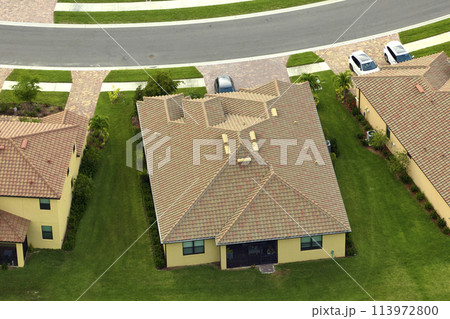 Aerial view of typical contemporary american private house with roof top covered with ceramic shingles and double garage 113972800
