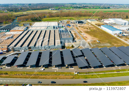 Aerial view of solar panels installed over parking lot with parked cars for effective generation of clean energy 113972807