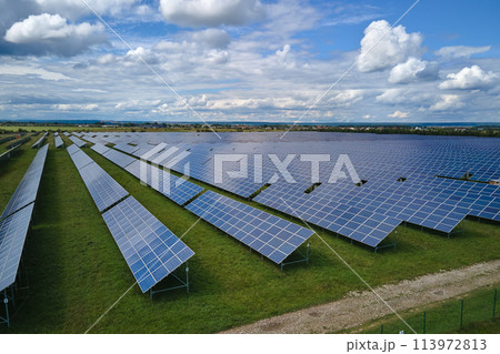 Aerial view of large sustainable electrical power plant with rows of solar photovoltaic panels for producing clean electric energy. Concept of renewable electricity with zero emission 113972813