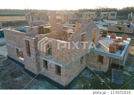 Industrial building site in rural area with residential houses under construction for future sale or leasing. Concept of real estate development Industrial building site in rural area with residential houses under construction for future sale or leasing. Concept of real estate development 113972818