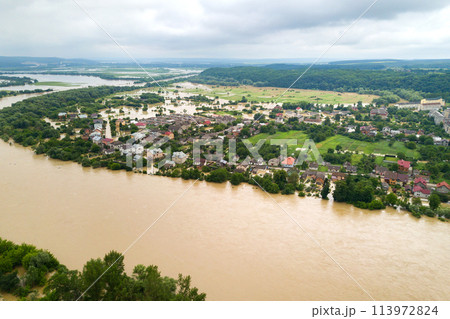 Aerial view of Dnister river with dirty water and flooded houses in Halych town, western Ukraine. Aerial view of Dnister river with dirty water and flooded houses in Halych town, western Ukraine. 113972824