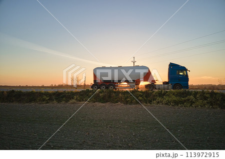 Aerial view of blurred fast moving cement cargo truck driving on highway hauling goods. Delivery transportation and logistics concept 113972915