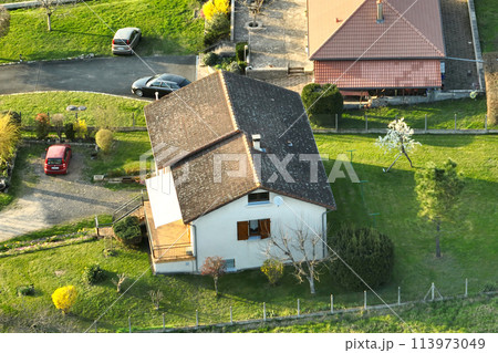 Aerial view of residential houses in green suburban rural area Aerial view of residential houses in green suburban rural area 113973049