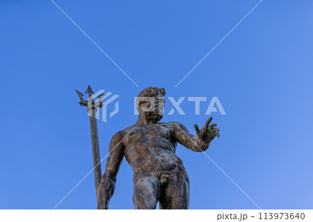 The bronze Neptune reaches towards the heavens, trident in hand, at Bologna Fountain of Neptune 113973640