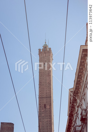 The Asinelli Tower in Bologna, Italy, stands tall against a clear blue sky 113973642