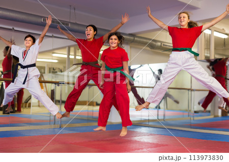 Children jumping with instructor at gym Children jumping with instructor at gym 113973830