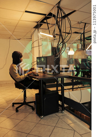 Encryption specialist using computer malware and virus to hack government network late at night, planning data breach to steal passwords. Hacker accessing important server and breaking system. 113975001