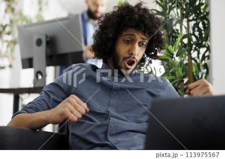 Start up company executive manager checking project performance statistics on laptop and celebrating success. Excited arab entrepreneur rejoicing stock market investment profit Start up company executive manager checking project performance statistics on laptop and celebrating success. Excited arab entrepreneur rejoicing stock market investment profit 113975567