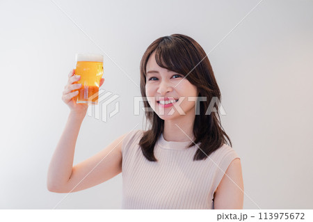 笑顔でビールを飲む若い女性 113975672
