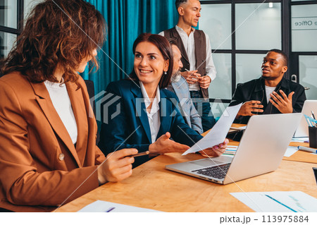 Business people in office work together during a meeting Business people in office work together during a meeting 113975884