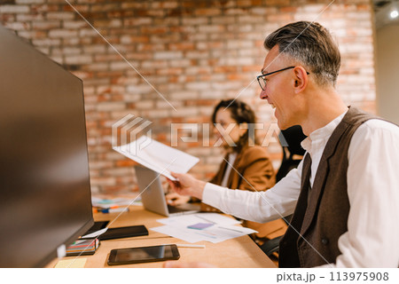 Business people in office work together during a meeting 113975908