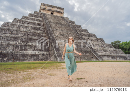 Beautiful tourist woman observing the old pyramid and temple of the castle of the Mayan architecture known as Chichen Itza these are the ruins of this ancient pre-columbian civilization and part of Beautiful tourist woman observing the old pyramid and temple of the castle of the Mayan architecture known as Chichen Itza these are the ruins of this ancient pre-columbian civilization and part of 113976918