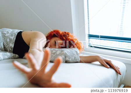 morning, young woman waking up in bed with natural hair under arms 113976919