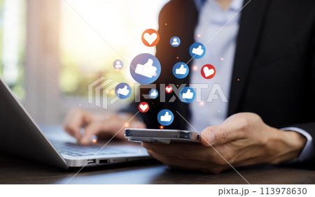 Hand holding smartphone and Social media and digital online concept, smart phone with Social media, concept of living on vacation and playing social media. Social Distancing 113978630