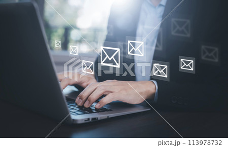 Businesswoman holding smartphone with communication icons, letter icon, email icons, and newsletter email and protect your personal information or spam mail, Customer service call center contact. 113978732