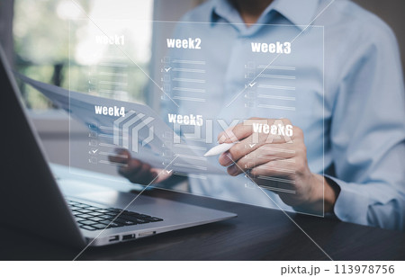 Businessman using a laptop and Taking an assessment, questionnaire, evaluation, online survey online exam Choosing the right answer in exam by filling out the online survey form,Answer  test questions 113978756
