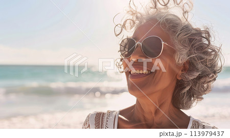 Joyful Mature African American Woman Enjoying a Sunny Beach Day, content expression outdoors 113979437