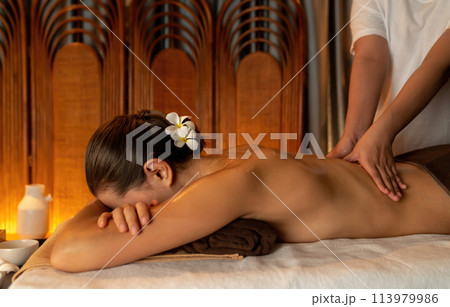Caucasian woman customer enjoying relaxing anti-stress massage. Quiescent Caucasian woman customer enjoying relaxing anti-stress massage. Quiescent 113979986