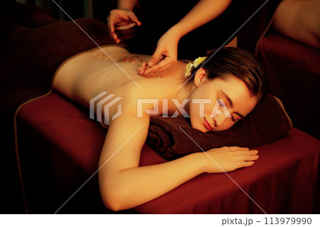 Woman customer having exfoliation treatment in luxury spa. Quiescent 113979990