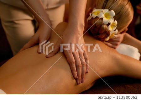 Closeup woman customer enjoying relaxing anti-stress massage. Quiescent Closeup woman customer enjoying relaxing anti-stress massage. Quiescent 113980062