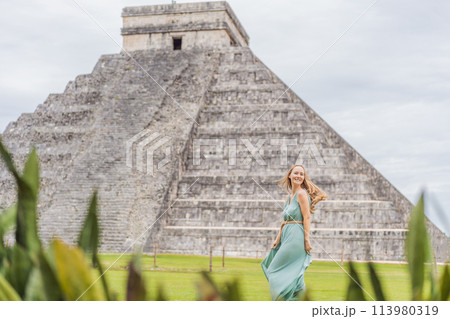 Beautiful tourist woman observing the old pyramid and temple of the castle of the Mayan architecture known as Chichen Itza these are the ruins of this ancient pre-columbian civilization and part of Beautiful tourist woman observing the old pyramid and temple of the castle of the Mayan architecture known as Chichen Itza these are the ruins of this ancient pre-columbian civilization and part of 113980319