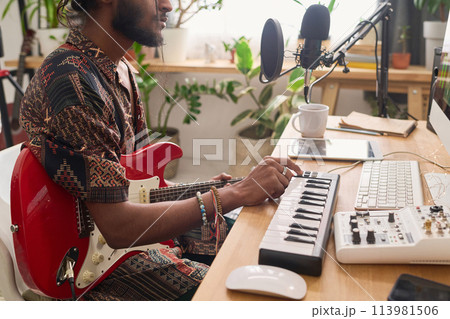 Guy creating new music and recording it 113981506