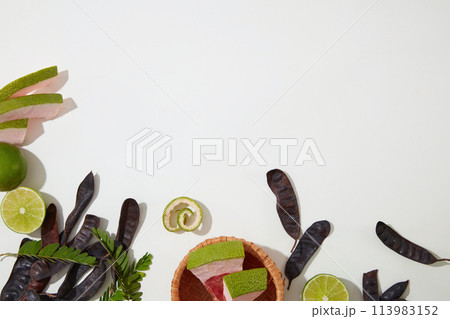 Fresh organic compositions flat lay on white table, lemon, grapefruit and black locust pod. Copy space for text with high angle shot Fresh organic compositions flat lay on white table, lemon, grapefruit and black locust pod. Copy space for text with high angle shot 113983152