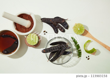 Ingredients for producing black locust pods products neatly arranged on white texture. Advertising photo with blank space for displaying product 113983158