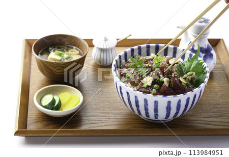 お盆にのせた 生かつおの漬け丼　（かつおの刺身を生姜のきいたタレに漬け込んで、豪快にごはんにのせた丼 113984951