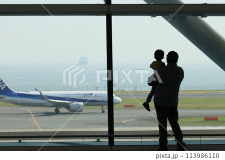羽田空港第2ターミナル国際線ロビー 飛行機を眺める乗客 親子 羽田空港第2ターミナル国際線ロビー 飛行機を眺める乗客 親子 113986110
