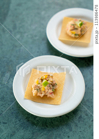salmon with fruits salad sauce on cracker 113986478
