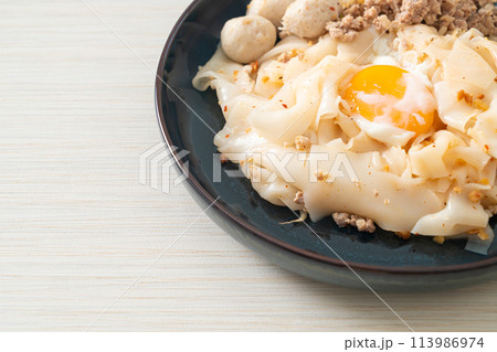 dried spicy noodles with minced pork, meatballs and egg dried spicy noodles with minced pork, meatballs and egg 113986974
