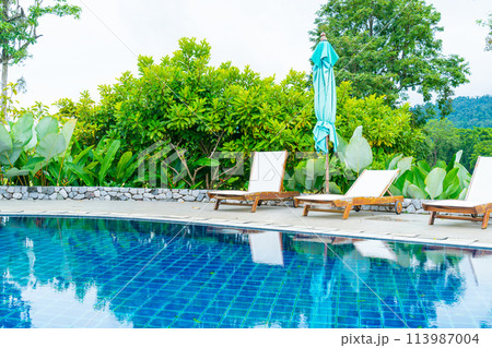 pool bed around swimming pool with mountain hill background 113987004