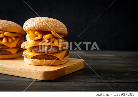 pork burger with cheese and french fries 113987203