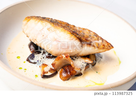 grilled Barramundi steak with mushroom sauce 113987325