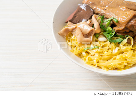 Egg noodles served dry with braised duck 113987473