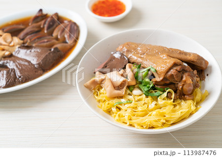 Egg noodles served dry with braised duck 113987476