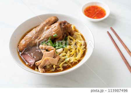egg noodles with stewed and braised duck in brown soup 113987496