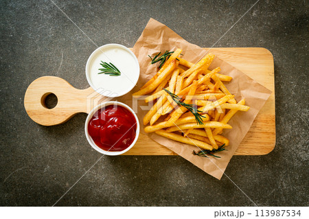 French fries with sour cream and ketchup 113987534