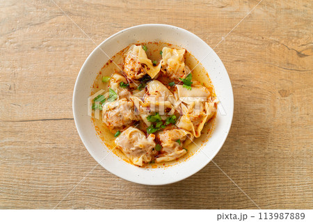 pork wonton soup or pork dumplings soup with roasted chili pork wonton soup or pork dumplings soup with roasted chili 113987889