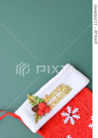 red wool winter sock on green background, christmas decoration 113989640