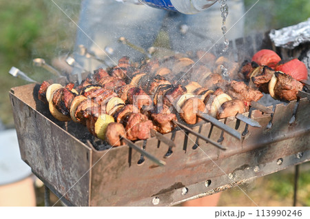 cooking a barbecue on the grill. put out the fire in the grill. cooking a barbecue on the grill. put out the fire in the grill. 113990246