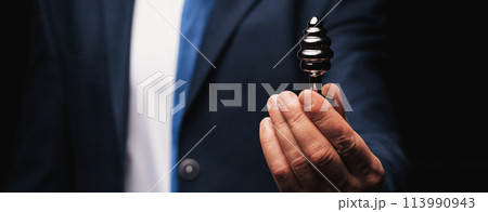metal butt plug in a man's hand. The concept of anal sex 113990943